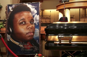A baseball cap and a portrait of Michael Brown is shown alongside his casket inside Friendly Temple Missionary Baptist Church before the start of funeral services in St. Louis